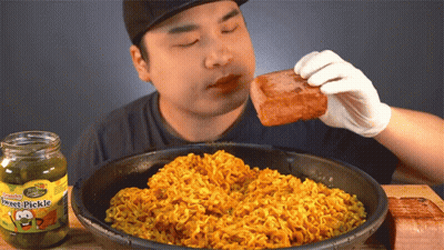 Man Eating Meat Next To Jar Of Hot Pickle GIF