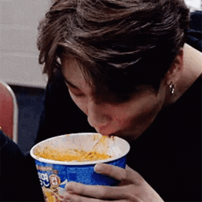 Man Eating Noodles From Blue Cup GIF
