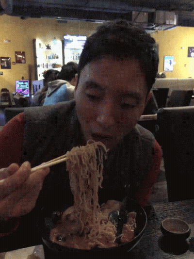 Man Eating Noodles With Chopsticks In Cafe GIF