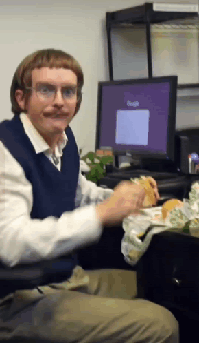 Man Eating Sandwich With Google On Screen GIF