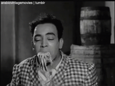 Man Eating Spaghetti In Black And White GIF