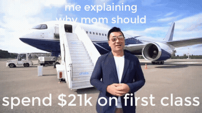 Man Explaining Why Mom Should Spend $21K On First Class In Front Of Airplane GIF