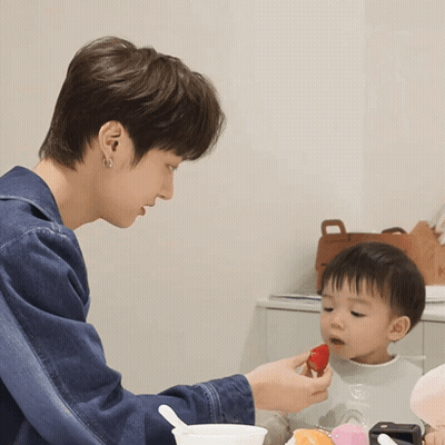 Man Feeding Baby Strawberry With Spoon GIF