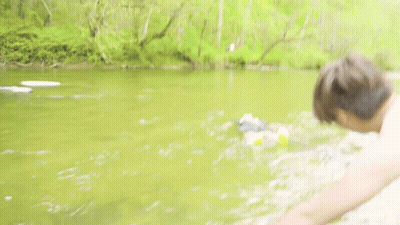 Man Fishing While Another Man Swimming GIF
