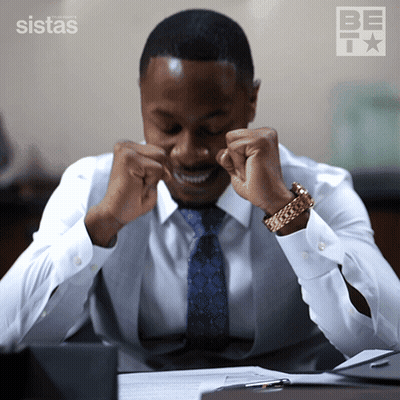 Man Fist Pumping In Front Of Be Sign GIF