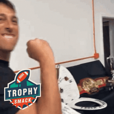 Man Flexing Arm With Trophy Smack Logo GIF