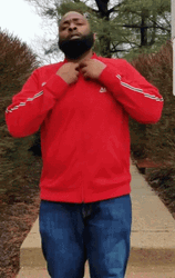 Man Flexing His T-Shirt With 100 Logo GIF