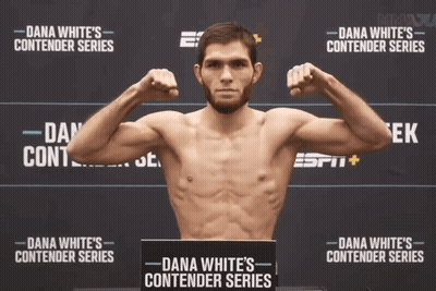 Man Flexing Muscles In Front Of Dana White Contender Series Poster GIF