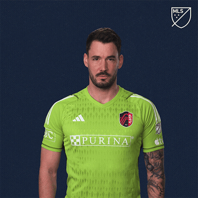 Man Flexing Muscles In Green Purina Shirt GIF