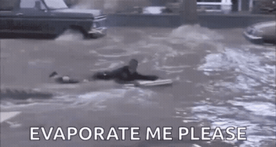 Man Floating On Surfboard In Flooded Street GIF