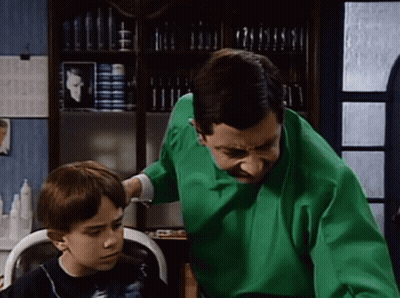 Man Getting Haircut At Barber Shop In Striped Cape GIF