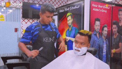 Man Getting Haircut By Man Wearing Keune Apron GIF