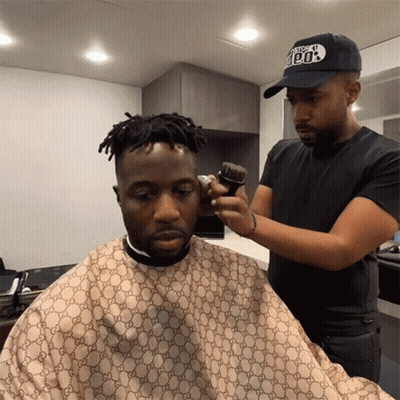 Man Getting Haircut By Man With 100% Hat GIF