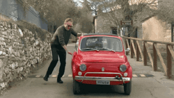 Man Getting Into A Small Fast Car GIF