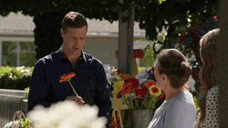 Man Giving Flowers To Elderly GIF