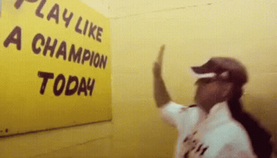Man Giving High Five In Front Of Play Like A Champion Today Sign GIF