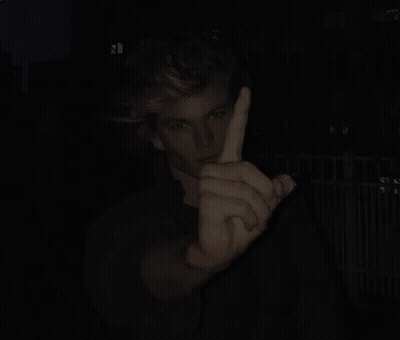 Man Giving Middle Finger In Dark GIF