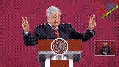 Man Giving Peace Sign At Mexico Podium GIF