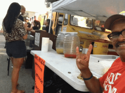Man Giving Peace Sign In Front Of King Presley Sign GIF