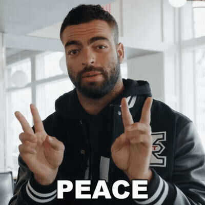 Man Giving Peace Sign Saying Peace GIF