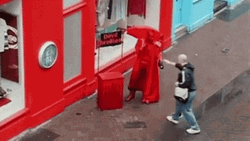 Man Giving Printed Umbrellas To People GIF