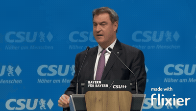 Man Giving Speech At Podium Saying Bayern GIF