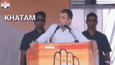 Man Giving Speech at Podium With Word Khatam