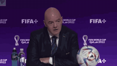 Man Giving Speech Beside Soccer Ball Saying Gay GIF