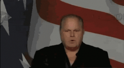 Man Giving Speech In Front Of Flag GIF