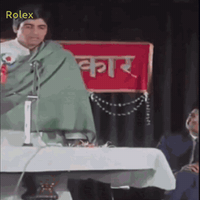 Man Giving Speech In Front Of Rolex Banner GIF