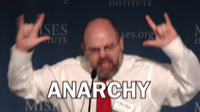 Man Giving Speech With Anarchy Behind GIF