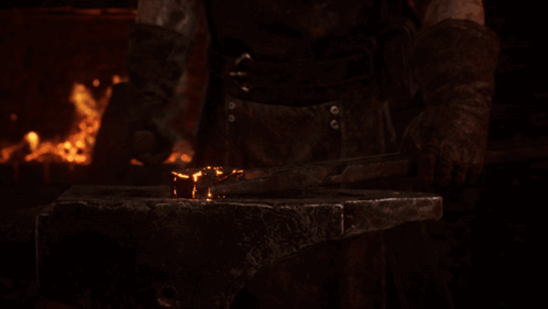 Man Hammering Metal On Anvil GIF