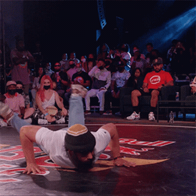 Man Handstanding Before Crowd In Red Bull Shirt GIF