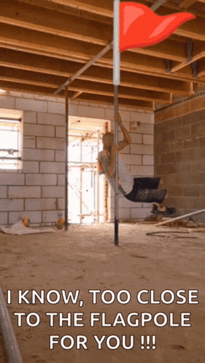 Man Hanging From Pole With Red Flag GIF