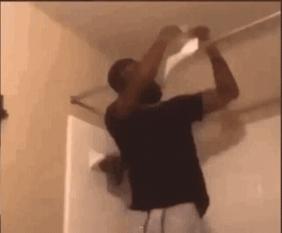 Man Hanging Paper From Ceiling GIF