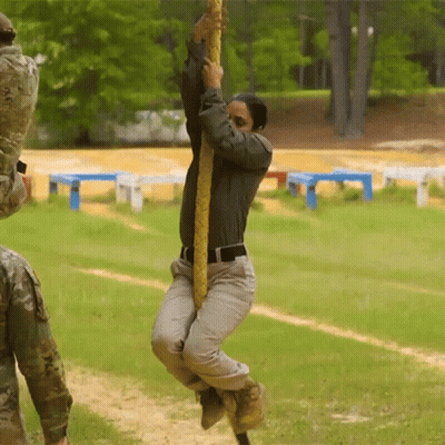 Man Hanging Upside Down On Rope In Field GIF