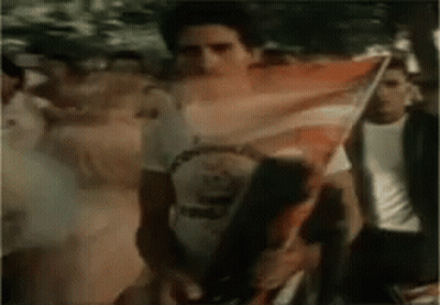 Man Holding American Flag In Front Of Crowd GIF