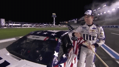 Man Holding American Flag Near Car Saying Lite GIF