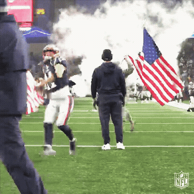 Man Holding American Flag On Field With NFL Logo GIF
