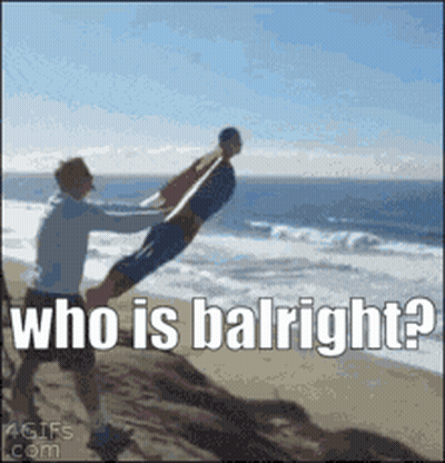 Man Holding Another Man On Beach Saying Who Is Balright GIF