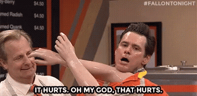 Man Holding Another Man's Arm Saying It Hurts GIF