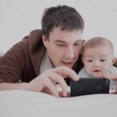 Man Holding Baby And Cell Phone GIF