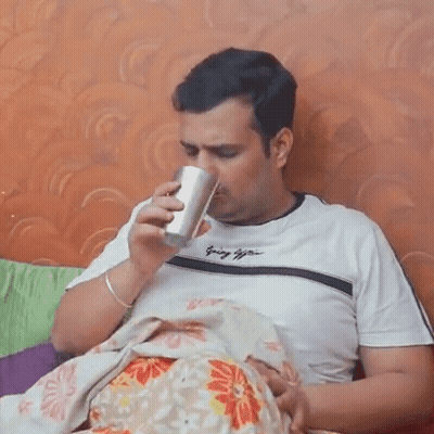 Man Holding Baby And Drinking From Cup GIF