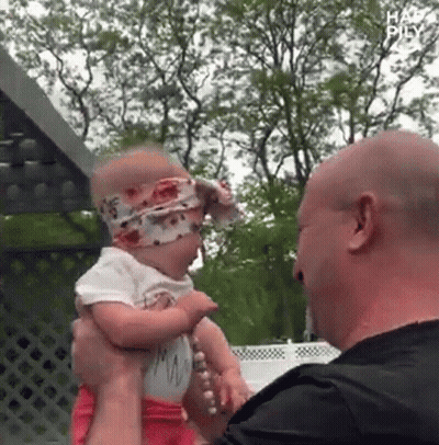 Man Holding Baby Girl With Headband