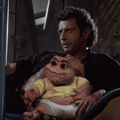 Man Holding Baby-Like Stuffed Animal GIF