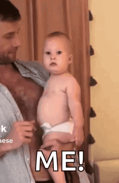 Man Holding Baby Saying Me GIF
