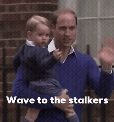 Man Holding Baby Saying Wave to the Stalkers