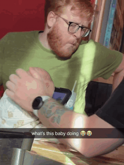 Man Holding Baby Snapchat Caption What's This Baby Doing GIF