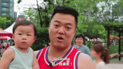 Man Holding Baby With Go Canada Shirt GIF