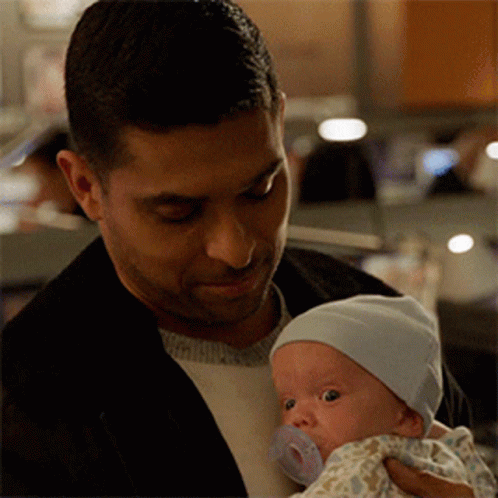Man Holding Baby With Pacifier GIF